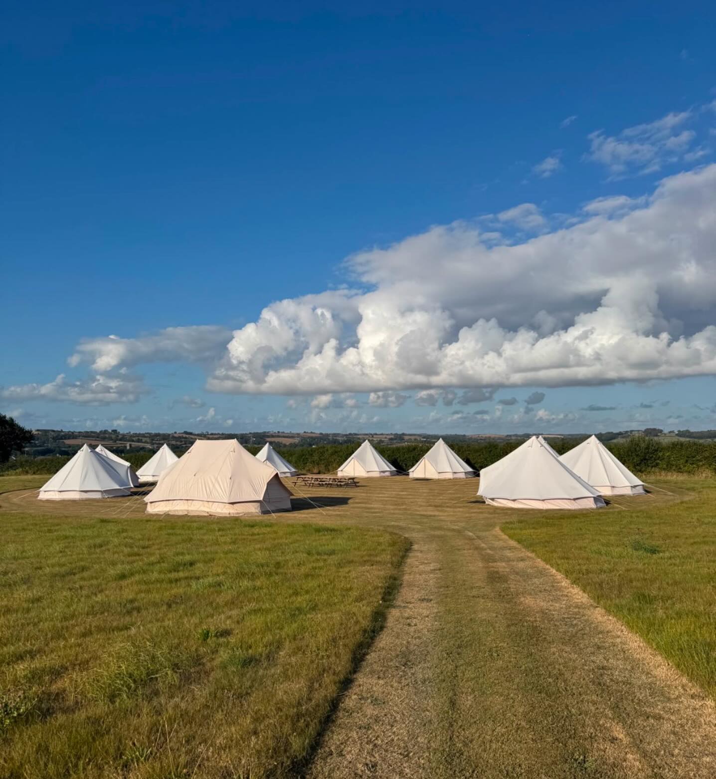 Gecko bell-tent village beneath a blue sky