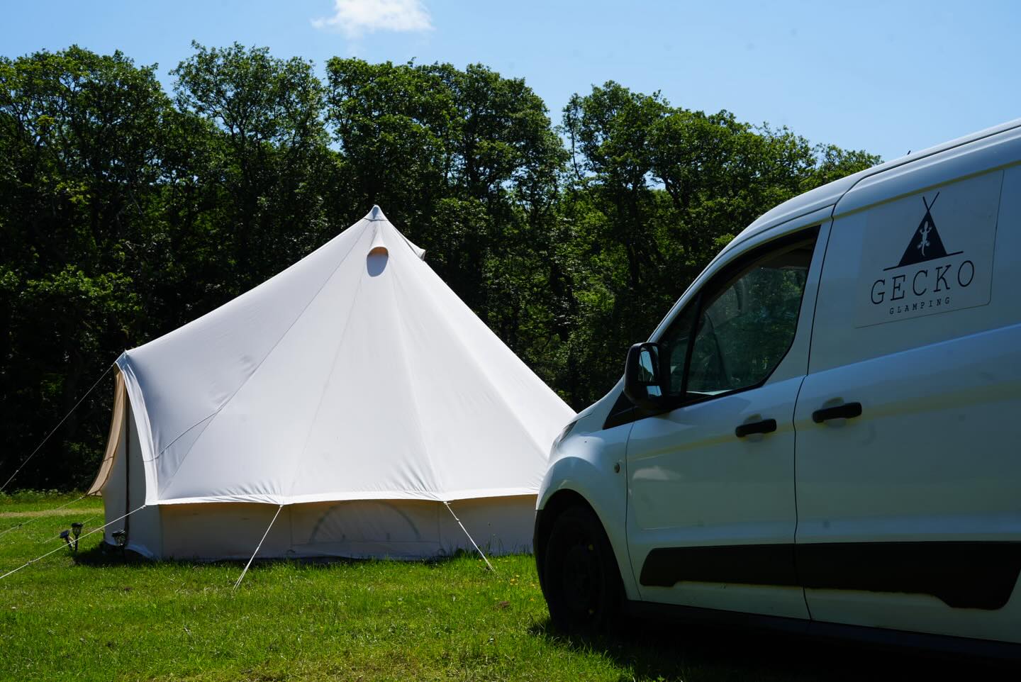 Gecko Glamping van beside a pitched bell tent